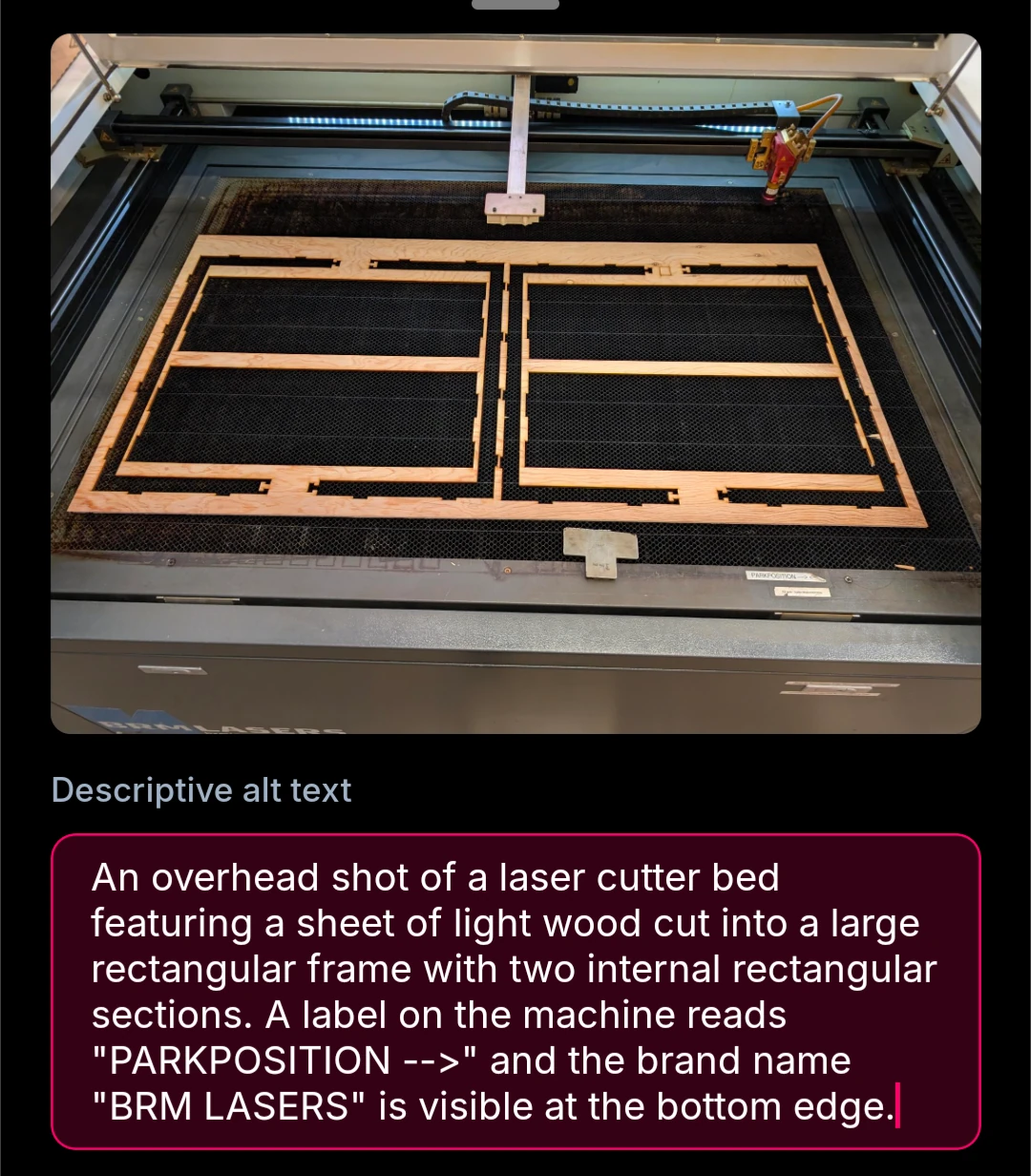 An overhead shot of a laser cutter bed featuring a sheet of light wood cut into a large rectangular frame with two internal rectangular sections. A label on the machine reads "PARKPOSITION -->" and the brand name "BRM LASERS" is visible at the bottom edge.