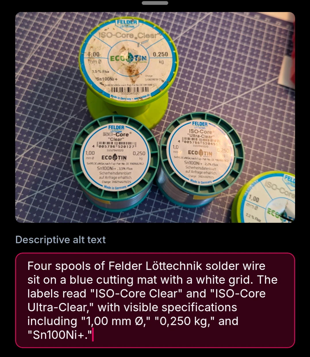 Four spools of Felder Löttechnik solder wire sit on a blue cutting mat with a white grid. The labels read "ISO-Core Clear" and "ISO-Core Ultra-Clear," with visible specifications including "1,00 mm "0,250 kg," and "Sn100Ni+."