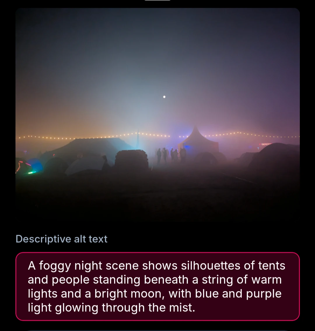 A foggy night scene shows silhouettes of tents and people standing beneath a string of warm lights and a bright moon, with blue and purple light glowing through the mist.
